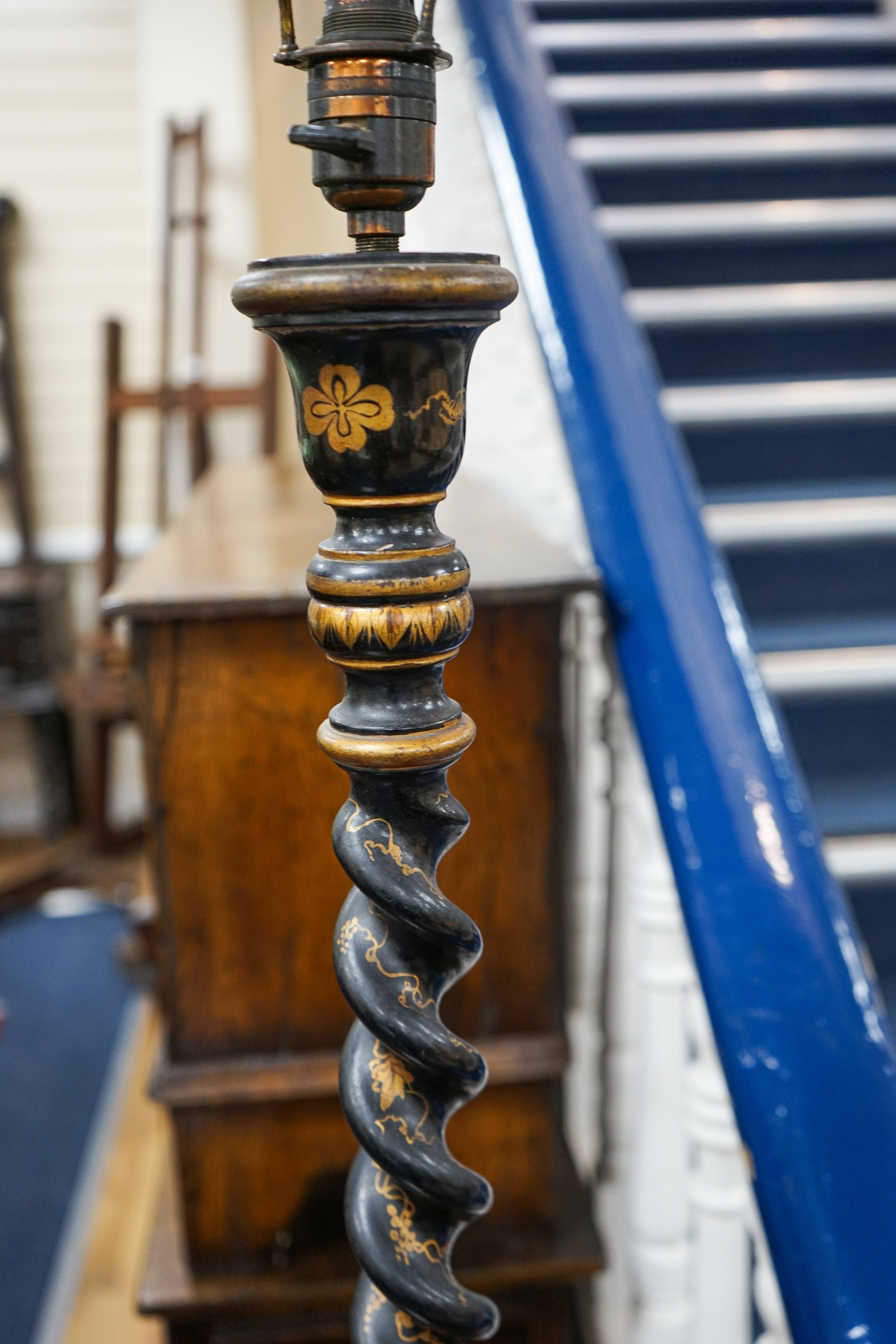 An early 20th century tall black-lacquered and gilt chinoiserie-decorated candlestick, having spiral-twist column (now converted to a lamp), H 72cm